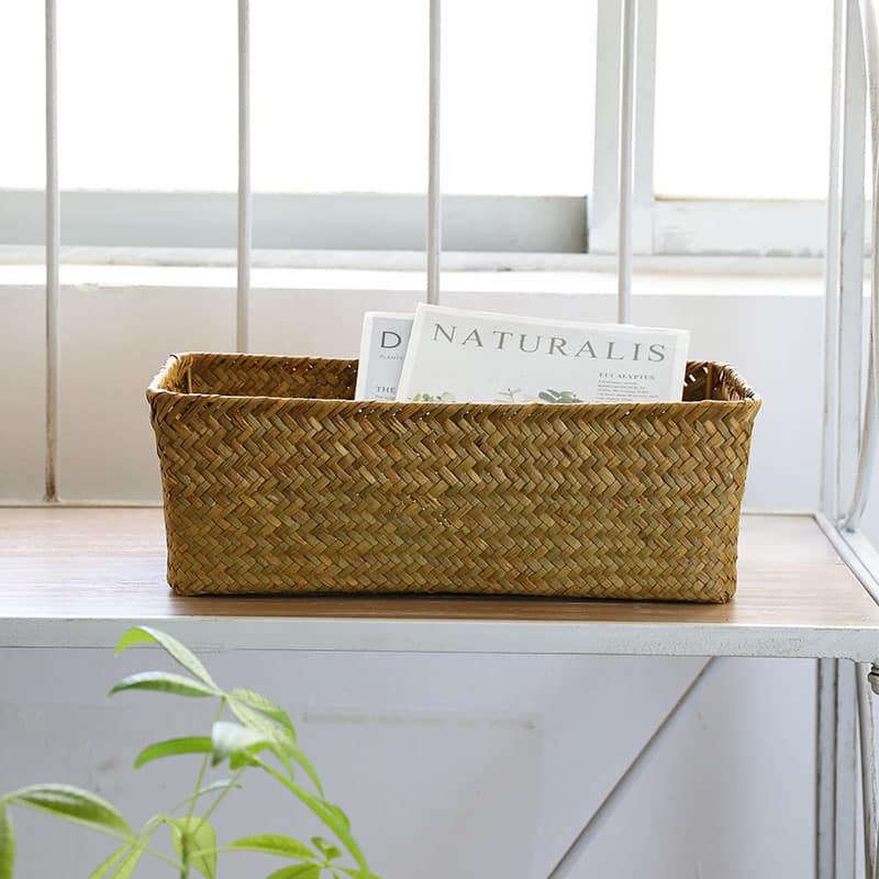 Small narrow rectangular woven baskets holding napkins and jars