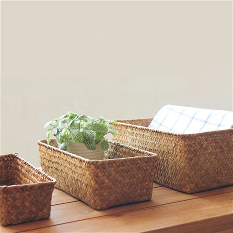 Small narrow rectangular woven baskets holding napkins and jars