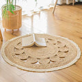 Small round jute rug with braided circles and a white fringe