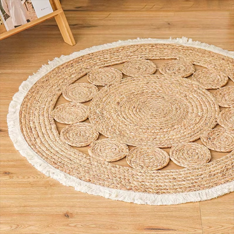 Small round jute rug with braided circles and a white fringe