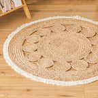 Small round jute rug with braided circles and a white fringe
