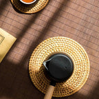 Small round hand woven rattan and bamboo mat with a tight even weave