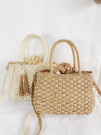 Small round hand woven rattan handbag with a double top handle and removable strap