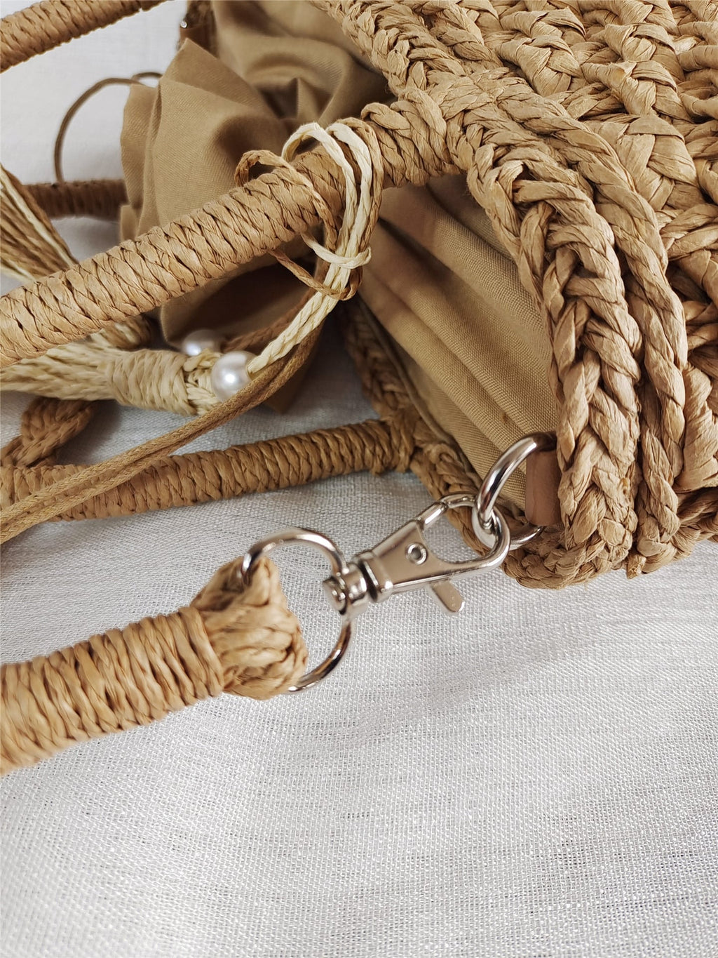 Small round hand woven rattan handbag with a double top handle and removable strap