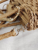Small round hand woven rattan handbag with a double top handle and removable strap