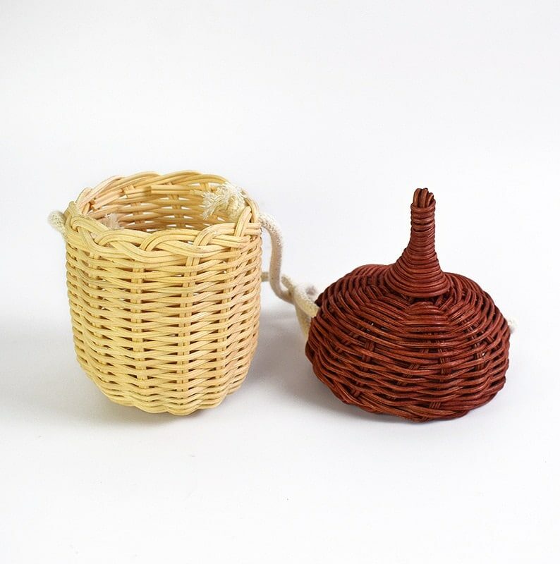 Small rounded hand woven rattan crossbody bag with an adjustable strap