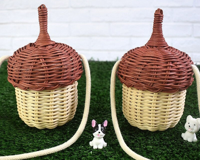 Small rounded hand woven rattan crossbody bag with an adjustable strap