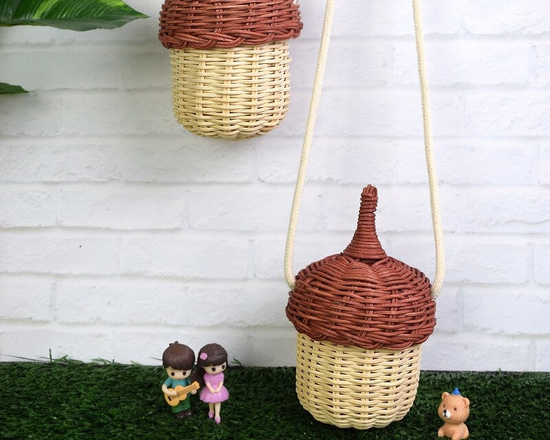 Small rounded hand woven rattan crossbody bag with an adjustable strap