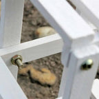 Small white wood shelf for plants and garden accessories