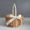 Small woven basket with white satin bow and wrapped handle