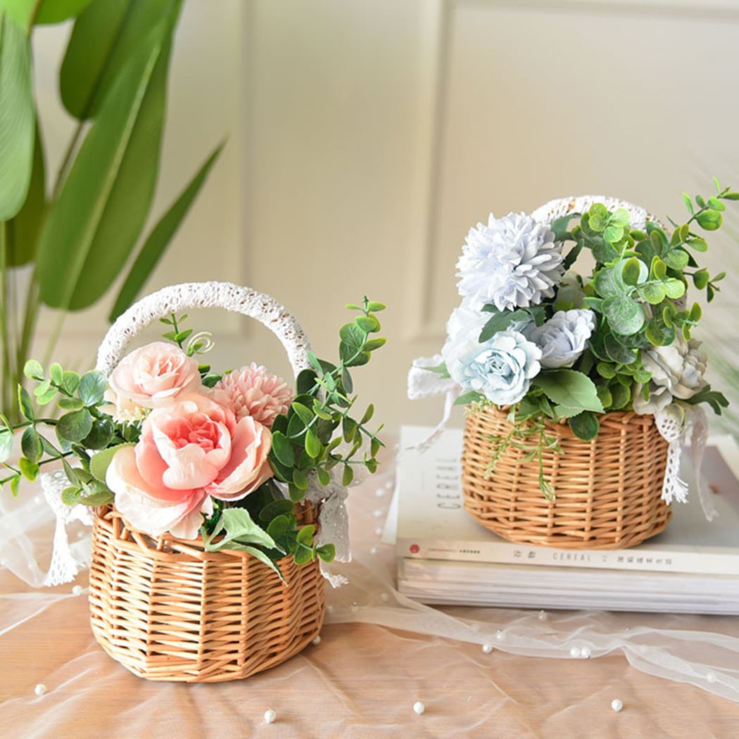 Two small woven baskets with lace wrapped handles and bows