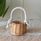 Two small woven baskets with lace wrapped handles and bows