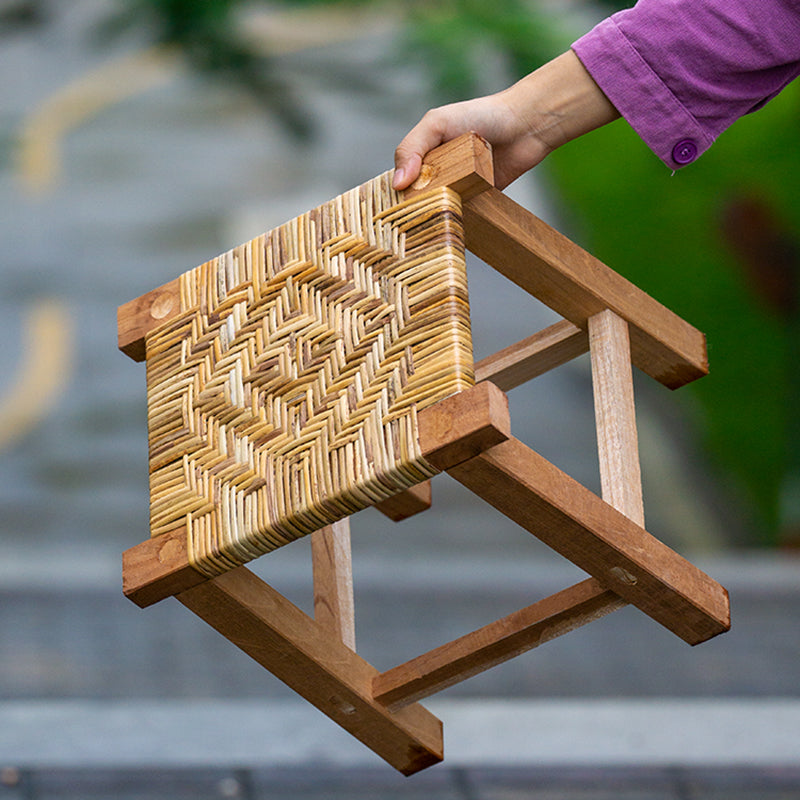Small square stool with a multi tone woven top on a solid wood frame