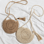 Soft round woven straw shoulder bag with a removable adjustable strap