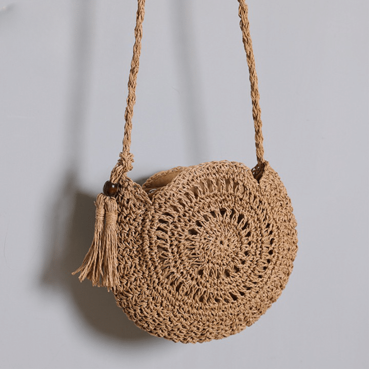 Soft round woven straw shoulder bag with a removable adjustable strap