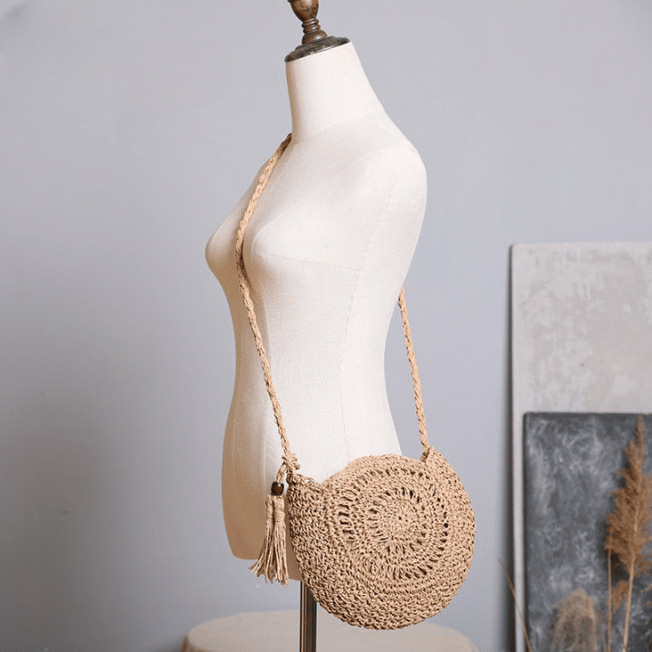 Soft round woven straw shoulder bag with a removable adjustable strap