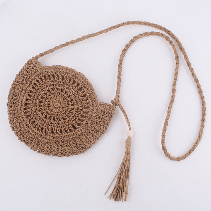 Soft round woven straw shoulder bag with a removable adjustable strap