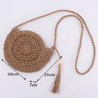 Soft round woven straw shoulder bag with a removable adjustable strap