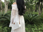 Square hand woven rattan shoulder bag in a boho style
