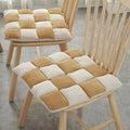 Square chair cushion with an off white and warm brown check pattern
