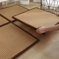 Square woven rattan floor mats with brown borders