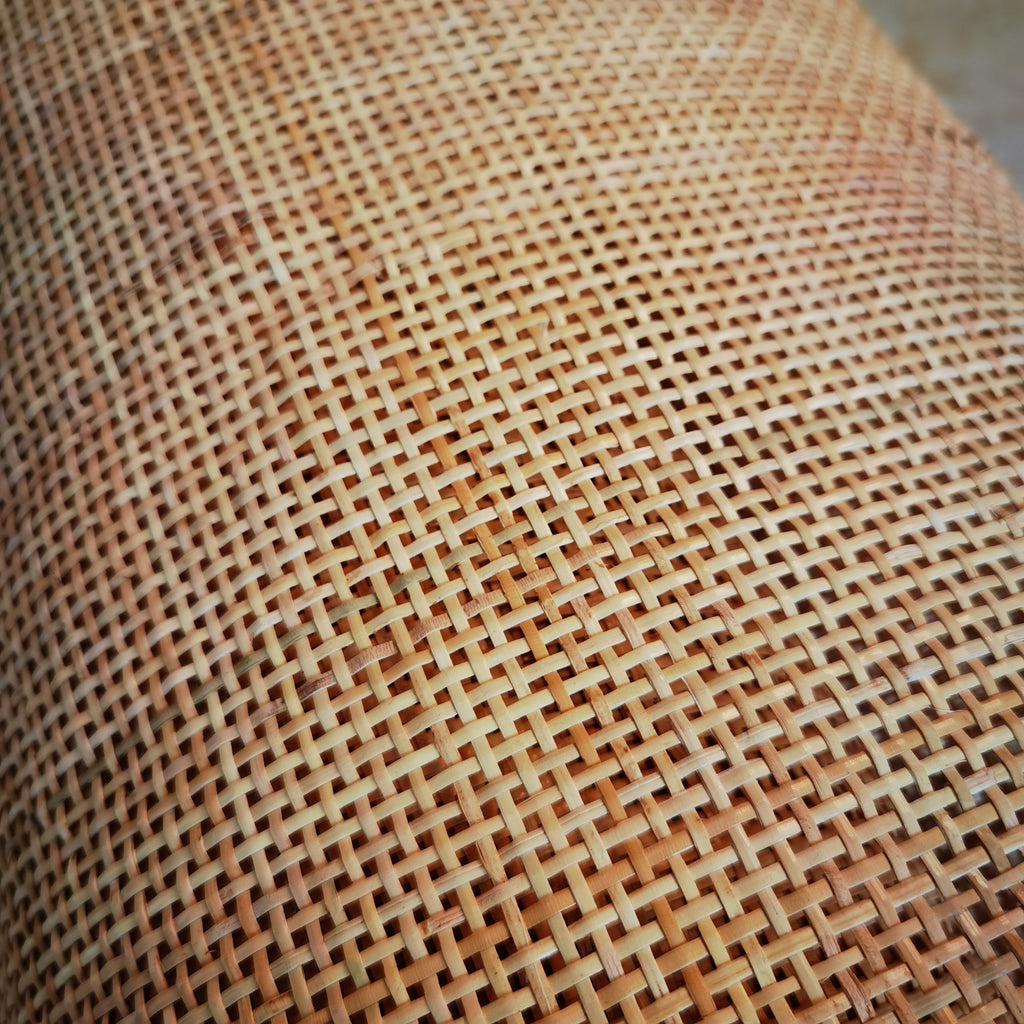 Roll of natural rattan cane webbing with a square open mesh