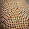 Roll of natural rattan cane webbing with a square open mesh