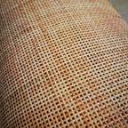 Roll of natural rattan cane webbing with a square open mesh