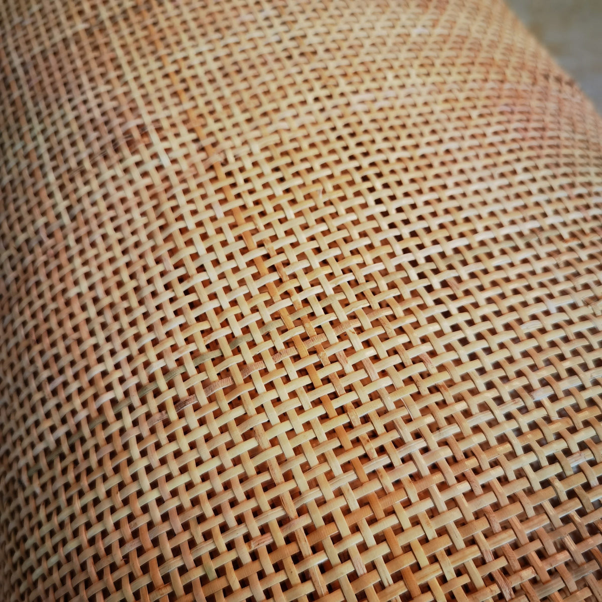 Roll of natural rattan cane webbing with a square open mesh