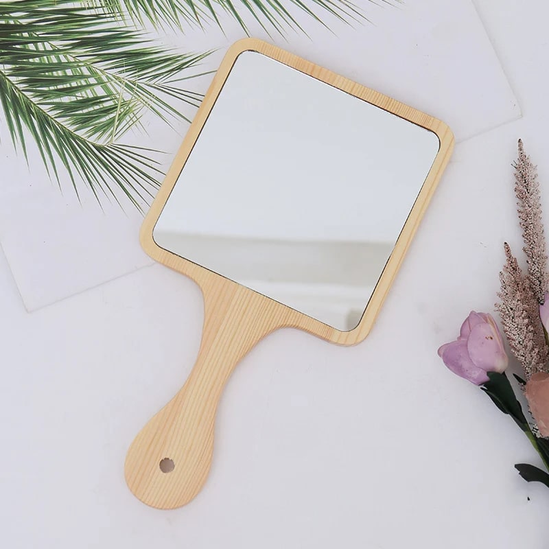 Square hand mirror with light wood frame and handle