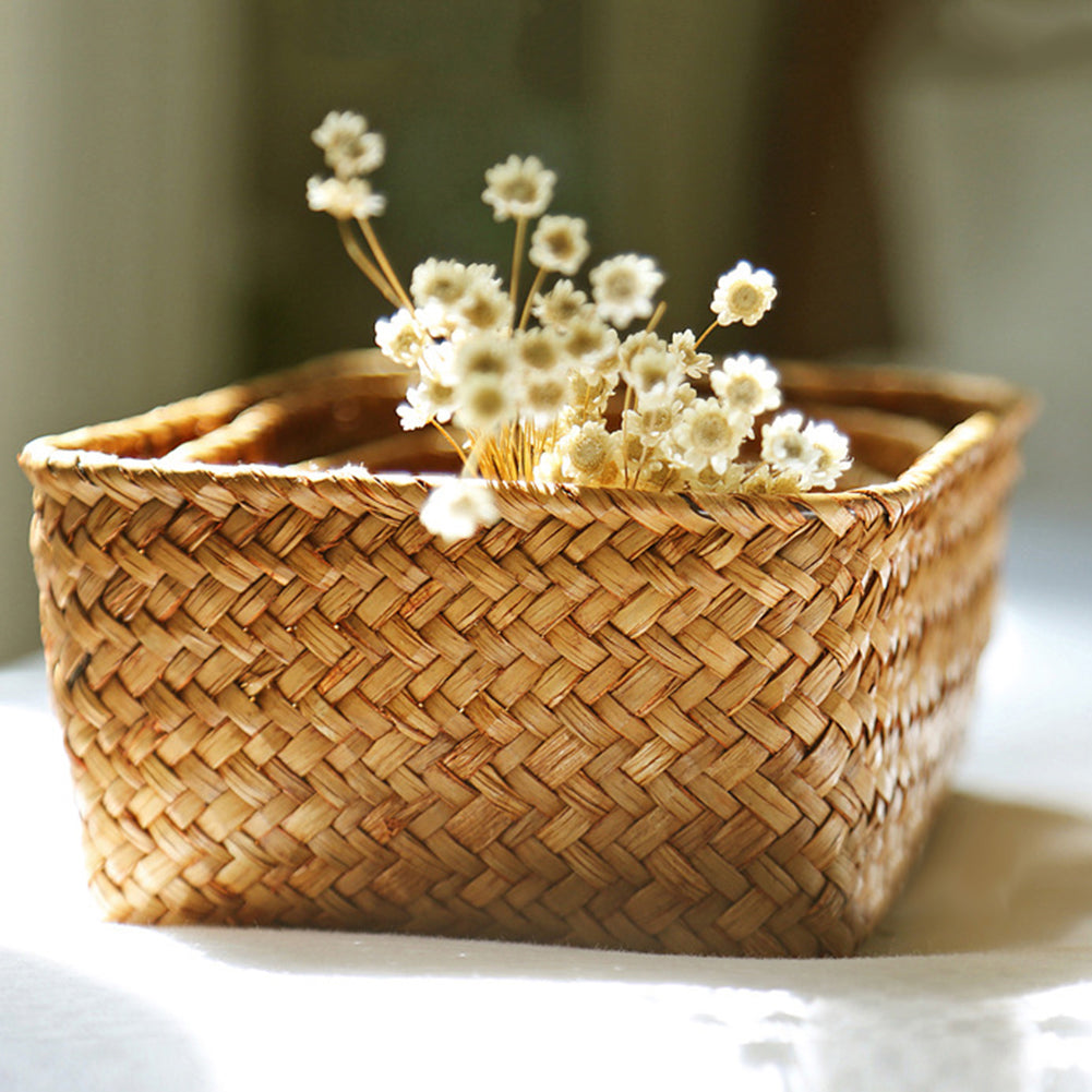 Square woven basket holding dried flowers