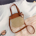 Hand woven straw handbag with smooth faux leather edging and strap