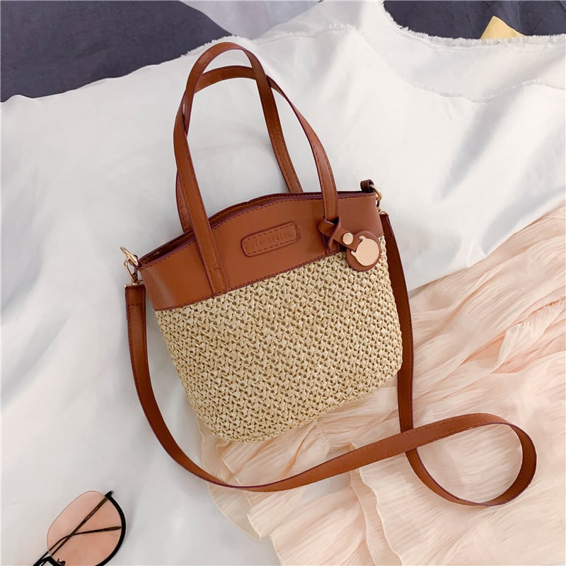 Hand woven straw handbag with smooth faux leather edging and strap
