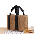 Structured summer handbag hand woven in natural straw with a honeycomb texture