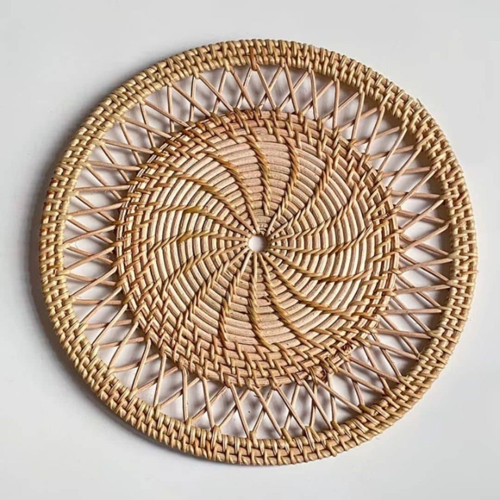 Round woven bamboo placemat with rays radiating from the center like a sun