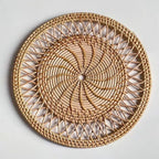 Round woven bamboo placemat with rays radiating from the center like a sun