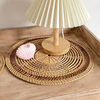 Round woven bamboo placemat with rays radiating from the center like a sun