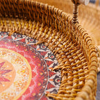 Round rattan tray with radiating sun weave and wooden handles