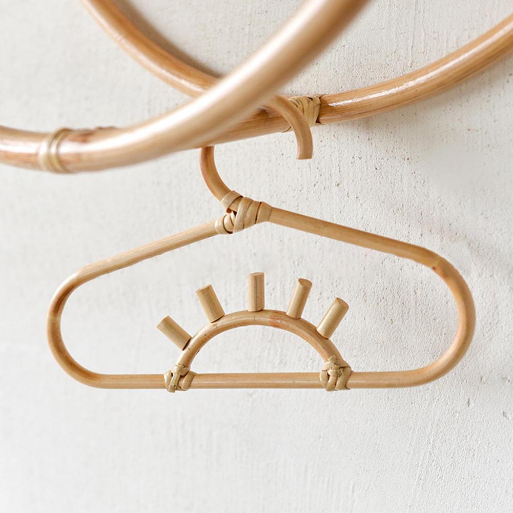 Kids' clothes hanger hand woven in natural rattan in a sun shape