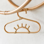 Kids' clothes hanger hand woven in natural rattan in a sun shape