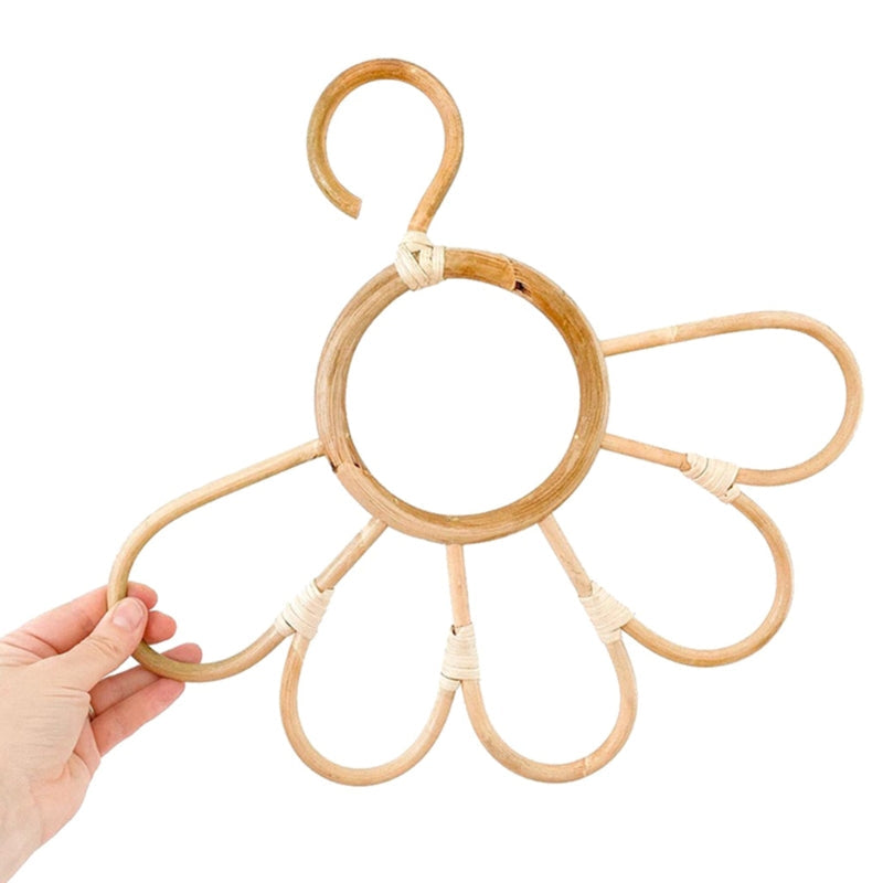 Kids' clothes hanger hand woven in natural rattan in a sunflower shape