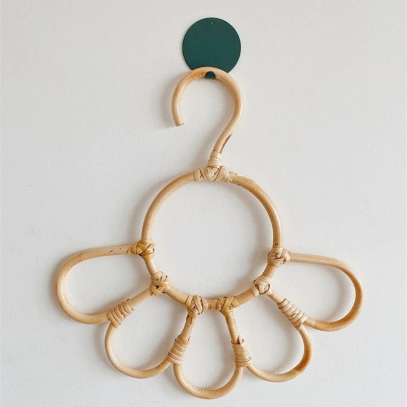 Kids' clothes hanger hand woven in natural rattan in a sunflower shape