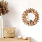 Round mirror surrounded by carved wooden sunflower petals