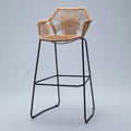 Bar chair with a hand woven beige synthetic rattan seat and hexagon back on black legs