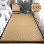 Synthetic rattan rug with a brown border beside a bed