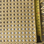 Roll of woven synthetic rattan webbing in beige or brown