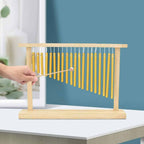 Tabletop bar chime with golden metal tubes on a bamboo wood stand