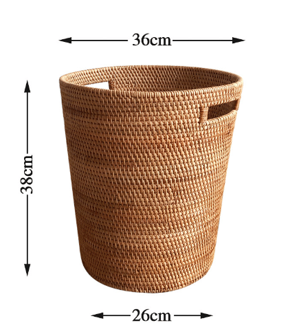 Tall honey rattan laundry basket with a towel draped over the rim
