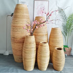 Group of tall natural bamboo floor vases in three heights