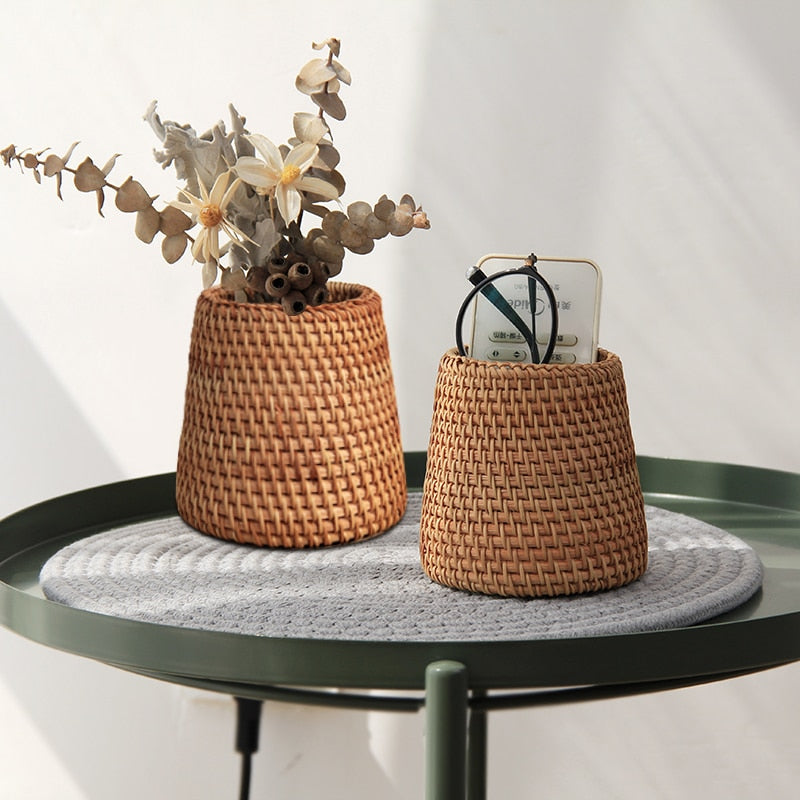 Small tapered woven rattan basket holding dried flowers